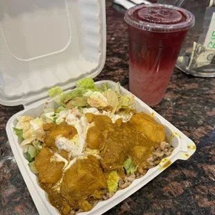 a take out container of food and a drink