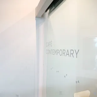 a table and chairs in front of a glass wall