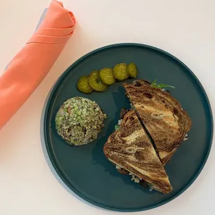 a sandwich and pickles on a plate