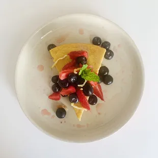 a plate of food with blueberries and strawberries
