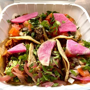 Taco box - 2 Asada, 2 Pibil, 1 Ground Beef Pink radish is pretty garnish, but no taste.  Stick with the burritos!