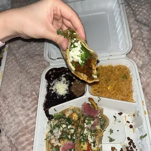 Taco Truck Box with soy chorizo, herb tofu, sautéed veggies. Corn tortilla. Half half beans. Rice.