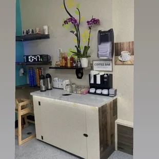 a small counter with a coffee maker