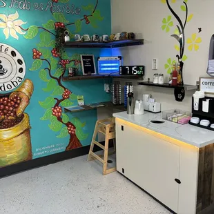 a coffee shop with a mural on the wall