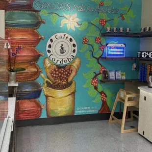 a coffee shop with a mural on the wall