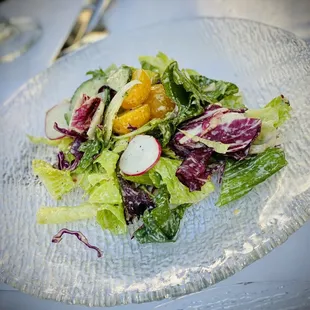 a plate of salad with radishes and radishes