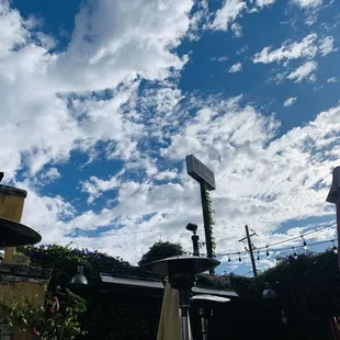 Powerful when you look up in a restaurant to see beautiful sky while Incased in greenery flowers