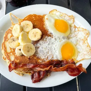 The Combo with Banana Nut pancakes, sunny side up eggs, and bacon!