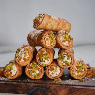 a stack of pastries on a cutting board