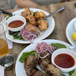 two plates of food on a wooden table