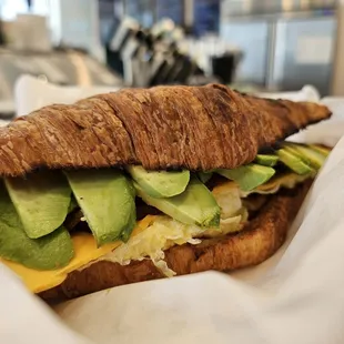 Croissant with avo, cheese bacon and the house sauce so good!