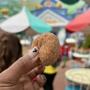 a person holding a donut in their hand