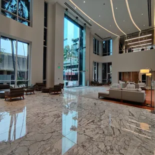 The back lobby of the condo building has a larger, brighter seating area