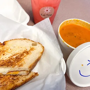 Ham and cheese sandwich with tomato soup and raspberry Italian soda