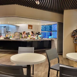 a man standing at a counter in a cafe