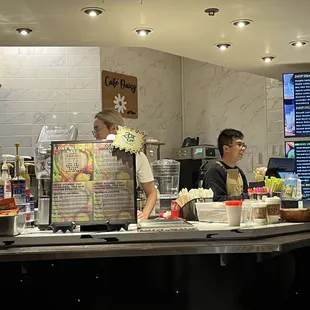 a man and a woman behind the counter