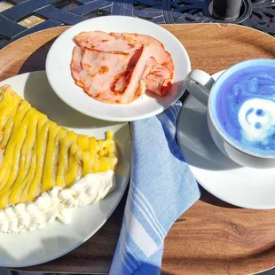 a plate of food and a cup of coffee