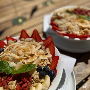 two bowls of fruit and granola
