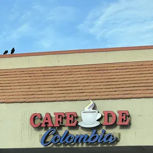 a bird perched on the sign