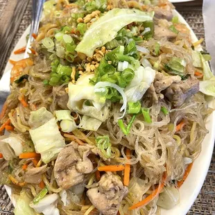 a plate of noodles with meat and vegetables