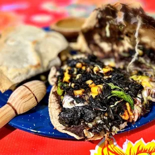 Tlayudas de Huitlacoche: Crispy Oaxacan quesadilla filled w/ corn smut, beans, quesillo cheese, cabbage, habanero salsa | $11