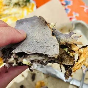 Crispy oaxacan quesadilla with asiento, quesillo cheese, beans, cabbage.