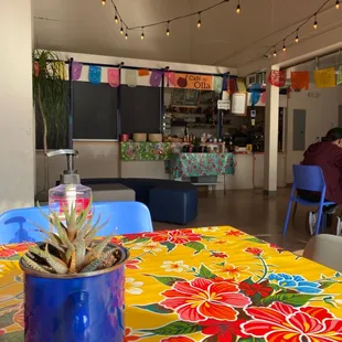 a colorful table cloth with a potted plant on it