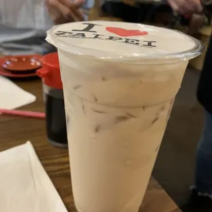 a cup of iced coffee on a table