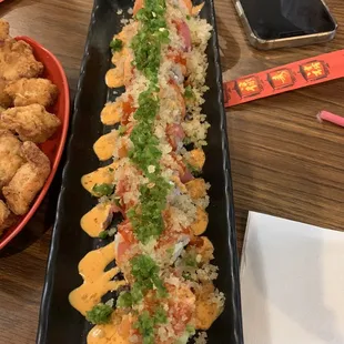 a sushi roll and a plate of fried tofu