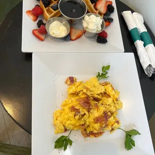 Berry waffle and traditional breakfast with bacon