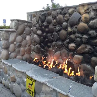 outdoor fireplace embedded with glass stones and seashells