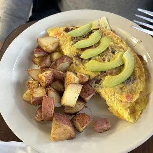 Bacon &amp; Avocado Omelet with roasted potatoes.
