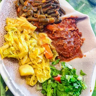 Individual plate with Fosolia (green beans), Tikil - Gomen (cabbage, potatoes, carrots), and Kaye Doro (berbere chicken)