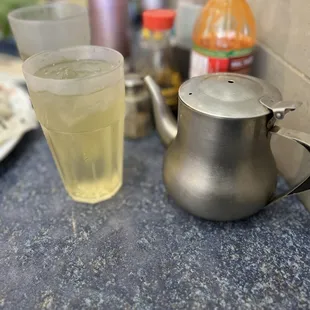 a teapot and a glass of water