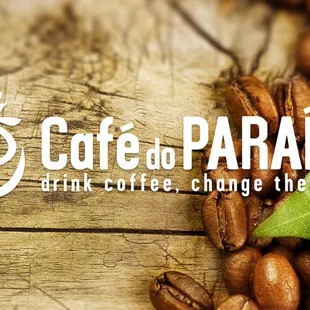 Cafe do Paraiso logo in white on a wood and coffee background.