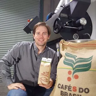 Our founder Owen Carver with our Petroncini Roasting machine and the first coffee we purchased direct from our friend's farm in Brazil.