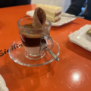 a cup of coffee with a donut in it