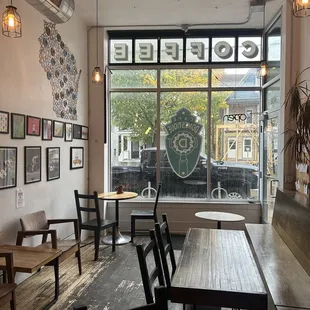 tables and chairs in front of a window
