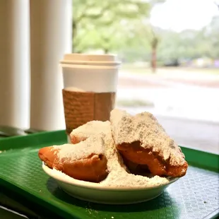 a plate of donuts and a cup of coffee