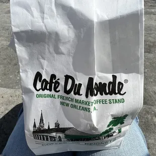 a person holding a bag of coffee