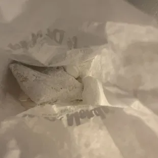 a sandwich wrapped in white paper
