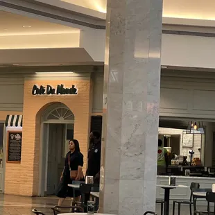people sitting at tables in a mall