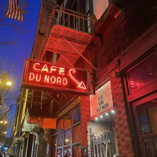 a neon sign on the side of a building