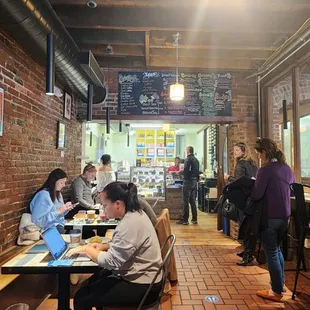 people sitting at tables in a cafe