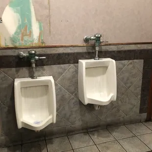 two urinals in a public restroom