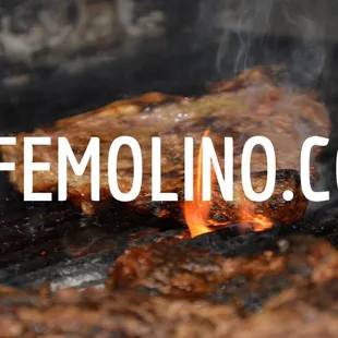 steaks cooking on a grill
