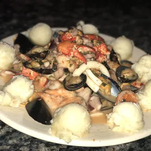 a plate of seafood and potatoes