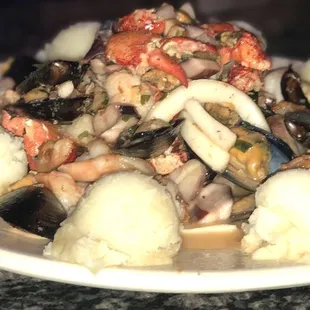a plate of seafood and potatoes