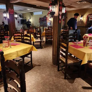 tables and chairs with yellow tablecloths