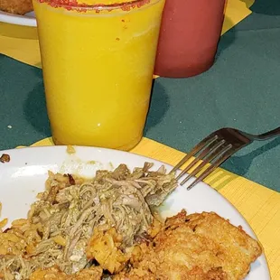 a plate of food and a glass of orange juice